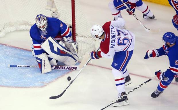 Henrik Lundqvist makes a save against Max Pacioretty